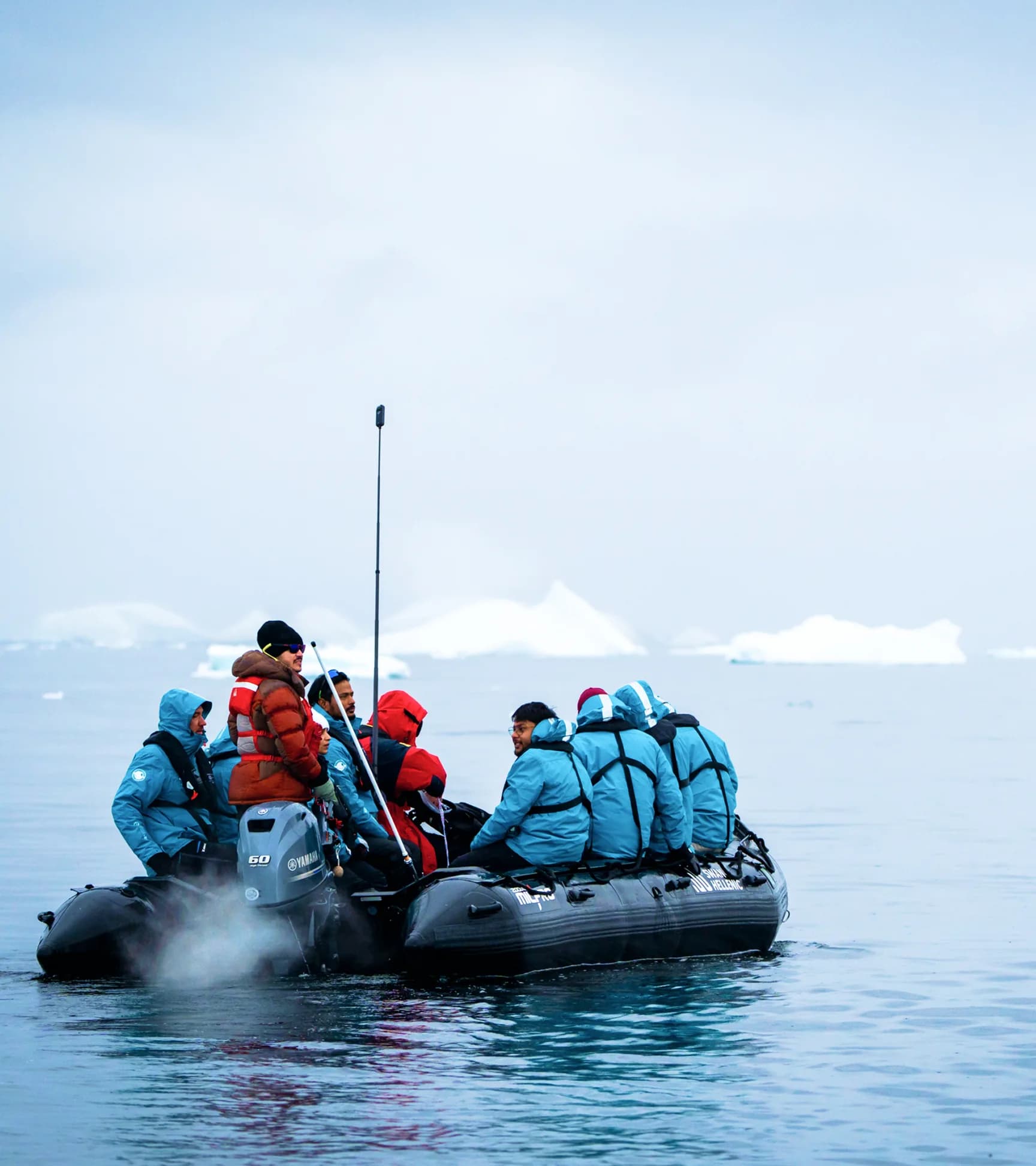 Guests in a Zodiac cruising among icebergs